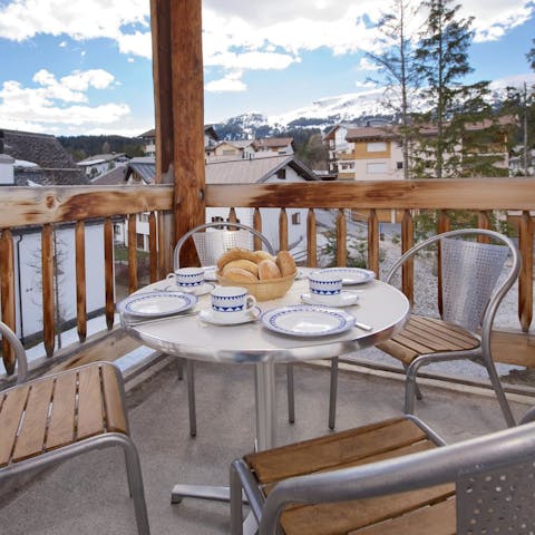 Enjoy breakfast on the balcony with a sneak peek at the ski runs in the distance