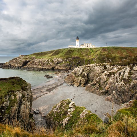Visit Killantringan Lighthouse, less than a ten-minute drive from your cottage