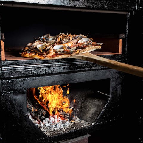 Embrace the rustic cuisine of Sicily with the wood-fired pizza oven