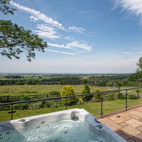 Soak in the hot tub with views over the countryside