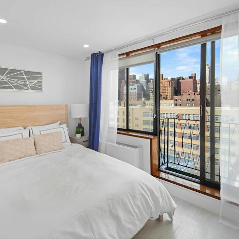 Enjoy the city views while relaxing in the bedroom