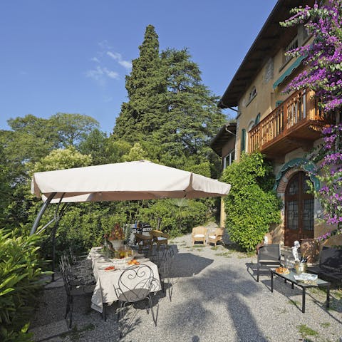 Dine alfresco beneath vivid hues of the bougainvillea