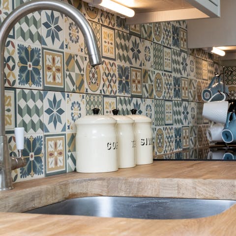 Whip up a delicious dinner in the small kitchen – we love the Portuguese-style tiles 