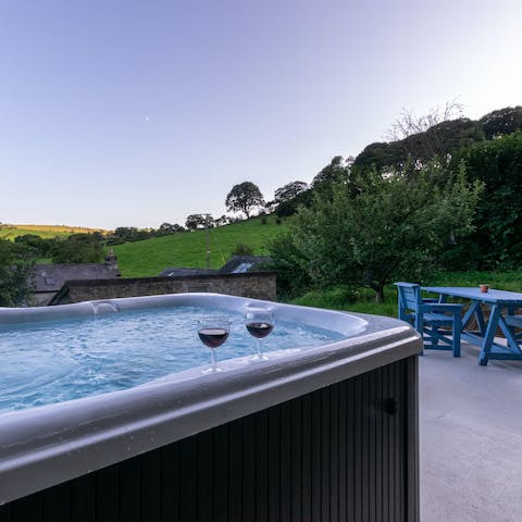 Soak in your private hot tub, watching the sunset with a glass of bubbly in hand