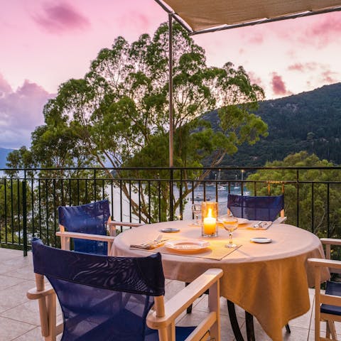Set up for a romantic dinner as the sun tinges the sky powder pink