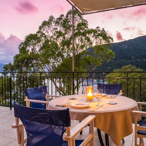 Set up for a romantic dinner as the sun tinges the sky powder pink