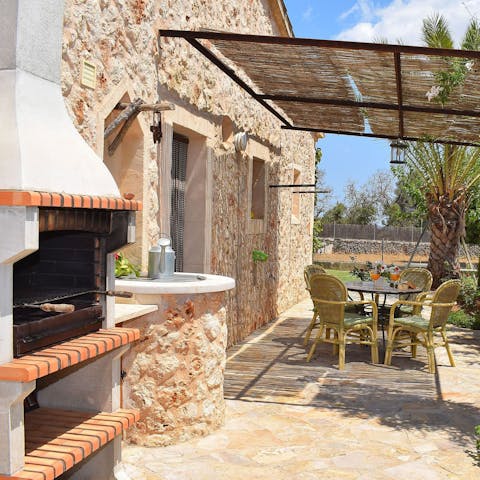 Cook up a feast on the barbecue and then enjoy it under the pergola