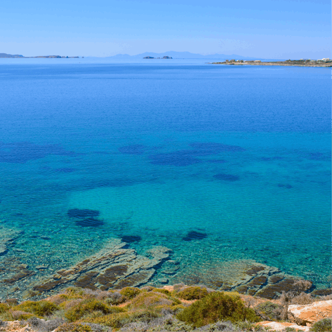 Take a refreshing dip at Parasporos Beach,  just a six-minute drive away