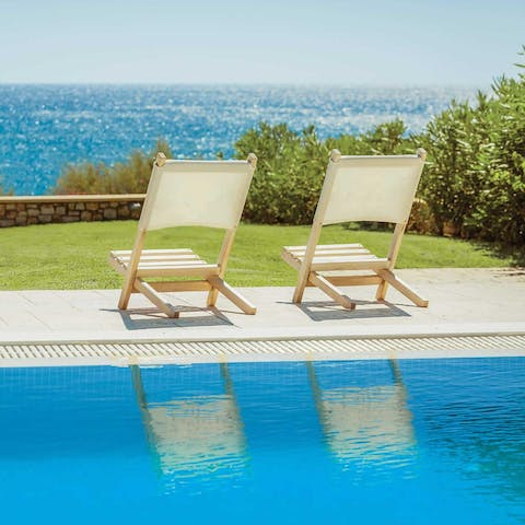 Sit back and soak up sunshine and sea views by the pool