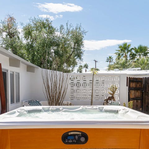 Unwind in the bubbling hot tub underneath the stars