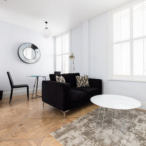 Kick back with a glass of wine in the stylish monochrome living before enjoying a night out in the West End