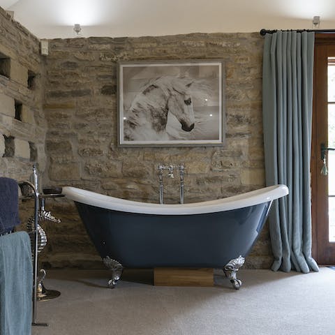 Finish the day with a rejuvenating soak in the blue freestanding bathtub