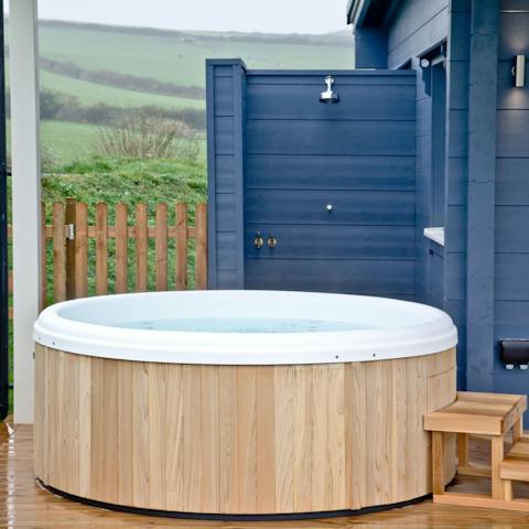 Soak your muscles in the hot tub with a glass of champagne in hand
