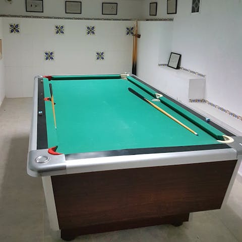 Challenge the competitive members of your group to a game of pool