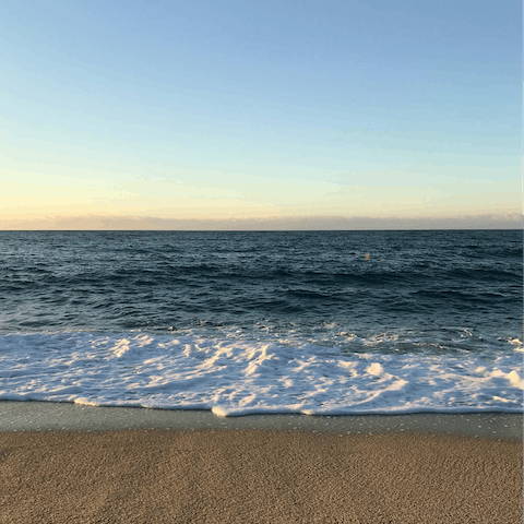 Stroll along the pebbles of Platja de la Grava, a short drive away