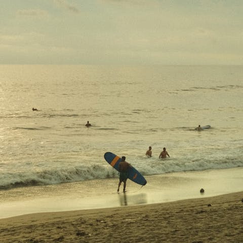 Head over to Seminyak beach to catch some waves