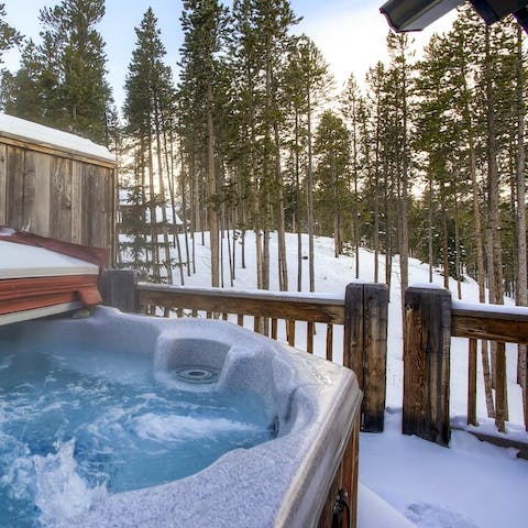 Watch the snow fall from inside the hot tub