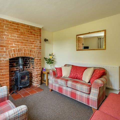 Enjoy a movie night in this cosy living room, with an exposed brick chimney breast