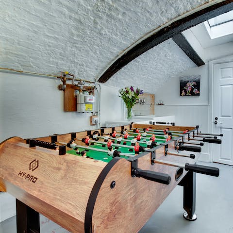 Play a friendly game of table football in the games room