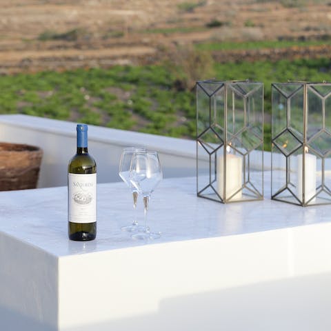 Watch the sunset with a glass of wine on the outdoor lounge