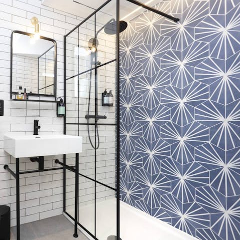 Get mornings off to a relaxing start with a soak under the tiled bathroom's rainfall shower