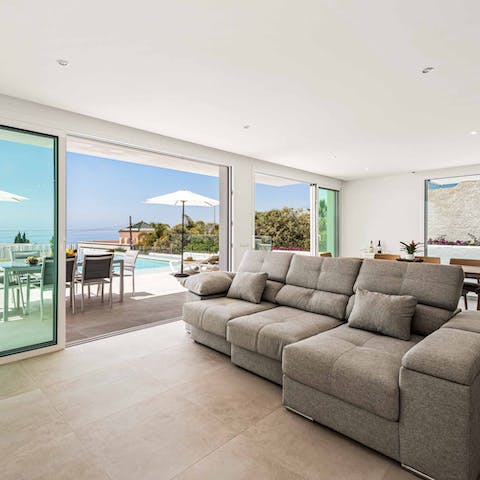 Slide open the floor-to-ceiling glass doors to let the sea breeze inside