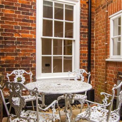 Enjoy your morning coffee while sitting on the courtyard's antique patio set