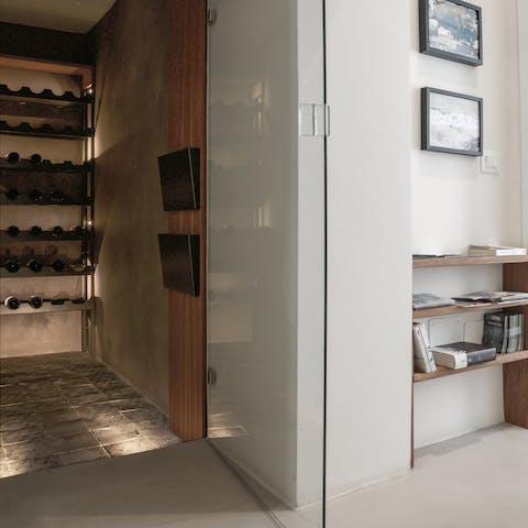 Enjoy a glass of wine – courtesy of the wine cellar – before relaxing on the living room's sofa