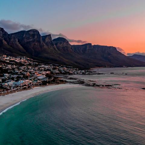 Watch the sunset at Camps Bay Beach, twenty minutes away