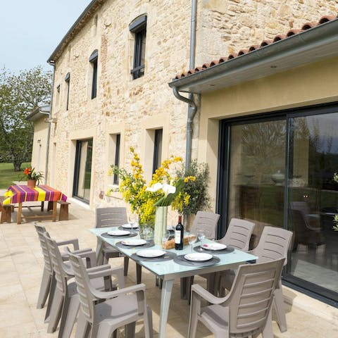 Set the alfresco dining table ready for lunch in the summer sun