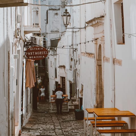 Wander around Ostuni's picturesque streets and end up in a osteria for some local grub