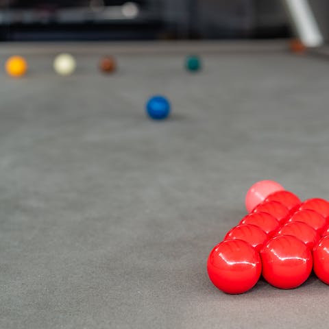 Go down to the basement's bar area and have a game of pool