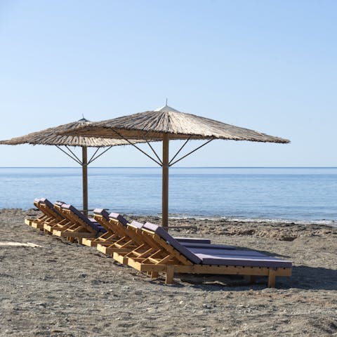 Soak up some sun on the shared loungers by the sea