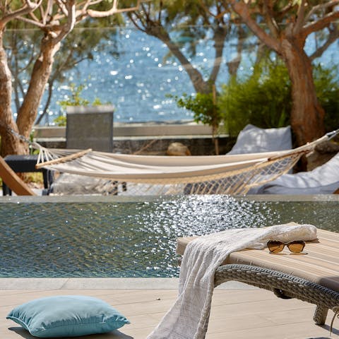 Lounge by the pool or swing in the hammock with a cocktail and a book