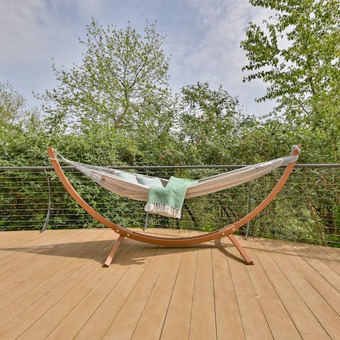 Swing about in the hammock while looking out at the forest, the perfect spot for a reading a good book