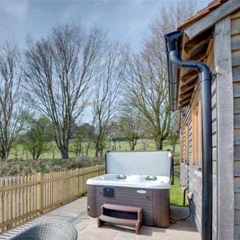 Soak sore muscles in your own private hot tub after a long walk through the vineyards