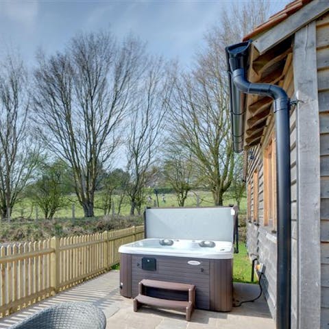 Soak sore muscles in your own private hot tub after a long walk through the vineyards 