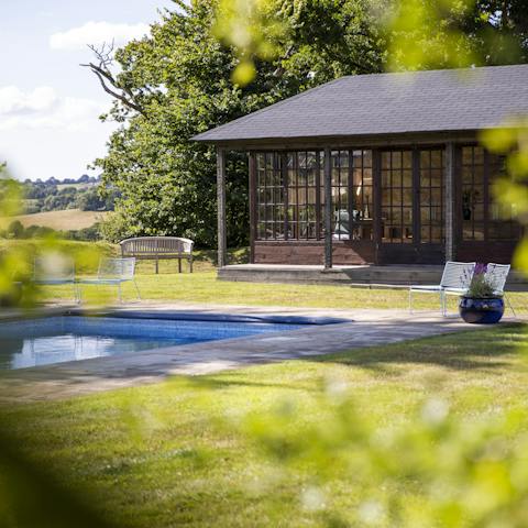 Soak up the sun by the pool on warm summer's days, or seek shade in the stunning poolhouse