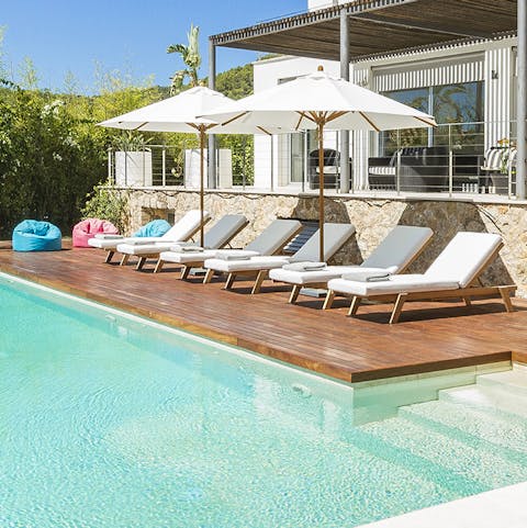 Laze on luxe loungers by the pool before cooling off with a refreshing dip