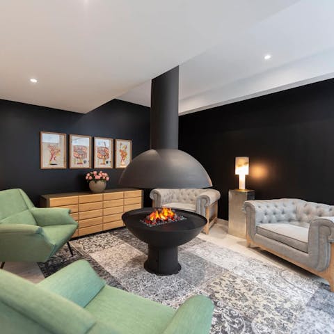 Cosy up by the shared lounge's fire, a glass of French wine in hand