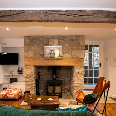 Unwind after a day of wandering around Wells Cathedral by the fireplace