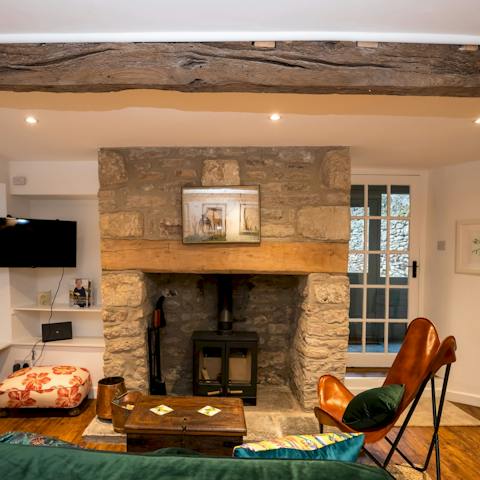 Unwind after a day of wandering around Wells Cathedral by the fireplace