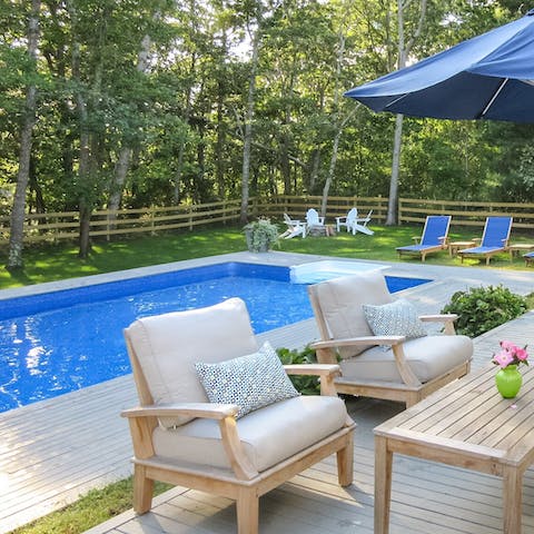 Take a dip in the pool as the sun streams through the trees