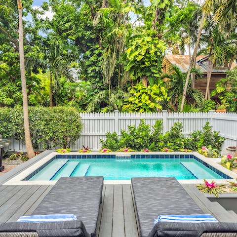 Spend sunny days relaxing beside by the pool in the tropical surroundings, catching up on your book
