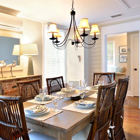 Get your glad rags on and gather around the grand dining table for dinners at home with the warm-toned light fixture setting the ambience