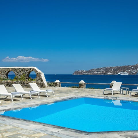 Take a refreshing dip in the pool overlooking the Aegean Sea