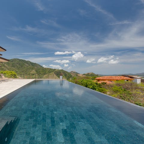 Slip into the infinity pool and gaze at the jungle and beach beyond