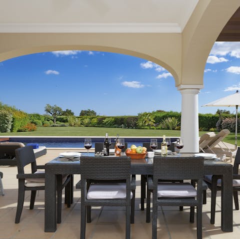 Dine on the shaded patio by the poolside