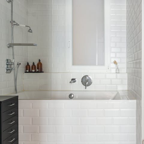 Sink into warm bubbles in the elegantly tiled bathtub after a long day on your feet
