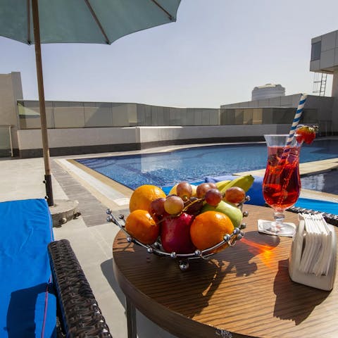 Hang out by the communal pool in the glistening Dubai sunshine